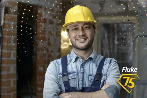 man wearing blue overalls and yellow hardhat with a fluke 75 year anniversary badge in corner